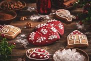 Glazed gingerbread homemade cookies on wooden background