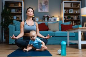 Young mom doing yoga in hopes of healthily losing weight after pregnancy.