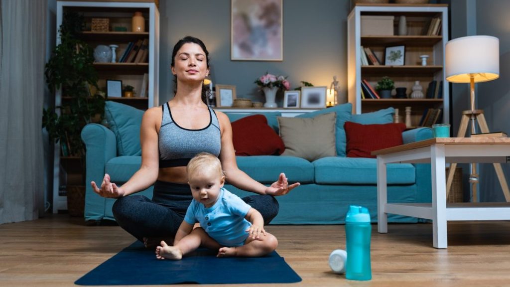 Young mom doing yoga in hopes of healthily losing weight after pregnancy.