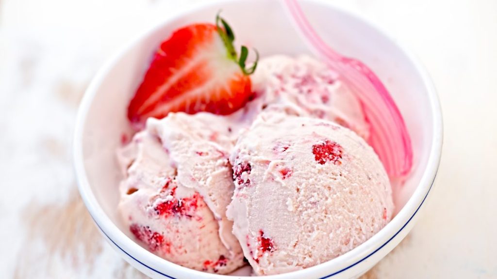 Strawberry cream ice cream in white bowl