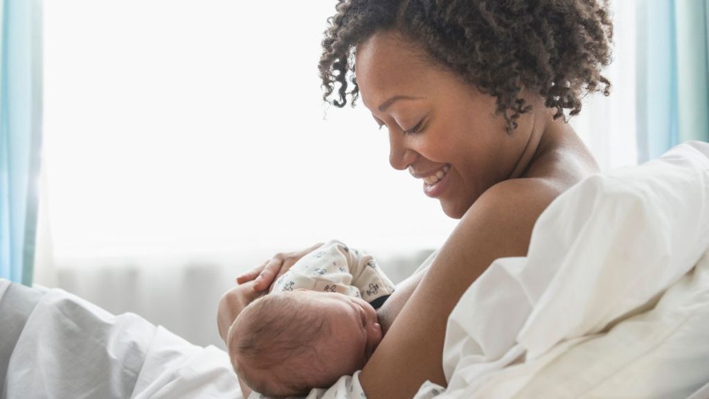 Young mother breastfeeding her newborn