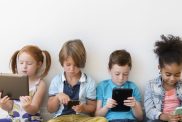 Kids sitting on their gadgets, scrolling through social media, which has now been banned for children under 16 in Australia.