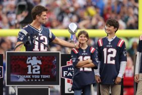 Former New England Patriots quarterback Tom Brady grabs his daughter's, Vivian, cheek while his sons, Benjamin and Jack, look on during a halftime ceremony during a game between the New England Patriots and the Philadelphia Eagles at Gillette Stadium on September 10, 2023 in Foxborough, Massachusetts.