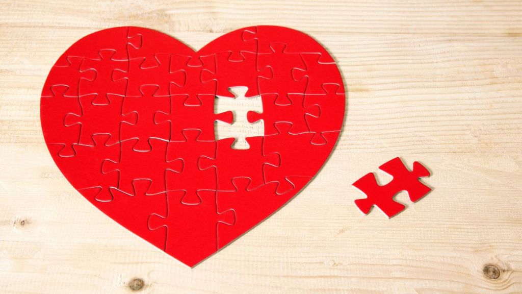 Heart shaped jigsaw puzzle with missing piece.